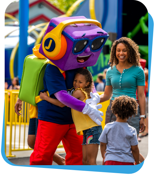A child hugging the Jolly Rancher mascot