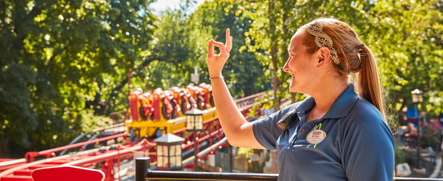 Hersheypark employee in front of Stormrunner roller coaster