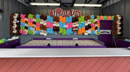 Try and land each ball on the red tins to win larger prizes