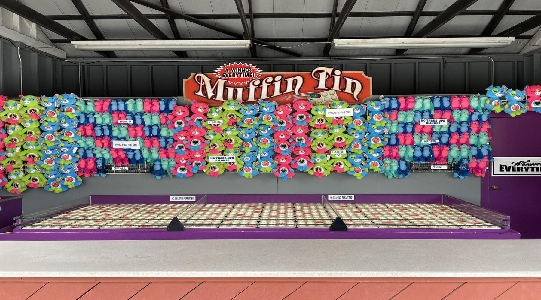 Try and land each ball on the red tins to win larger prizes