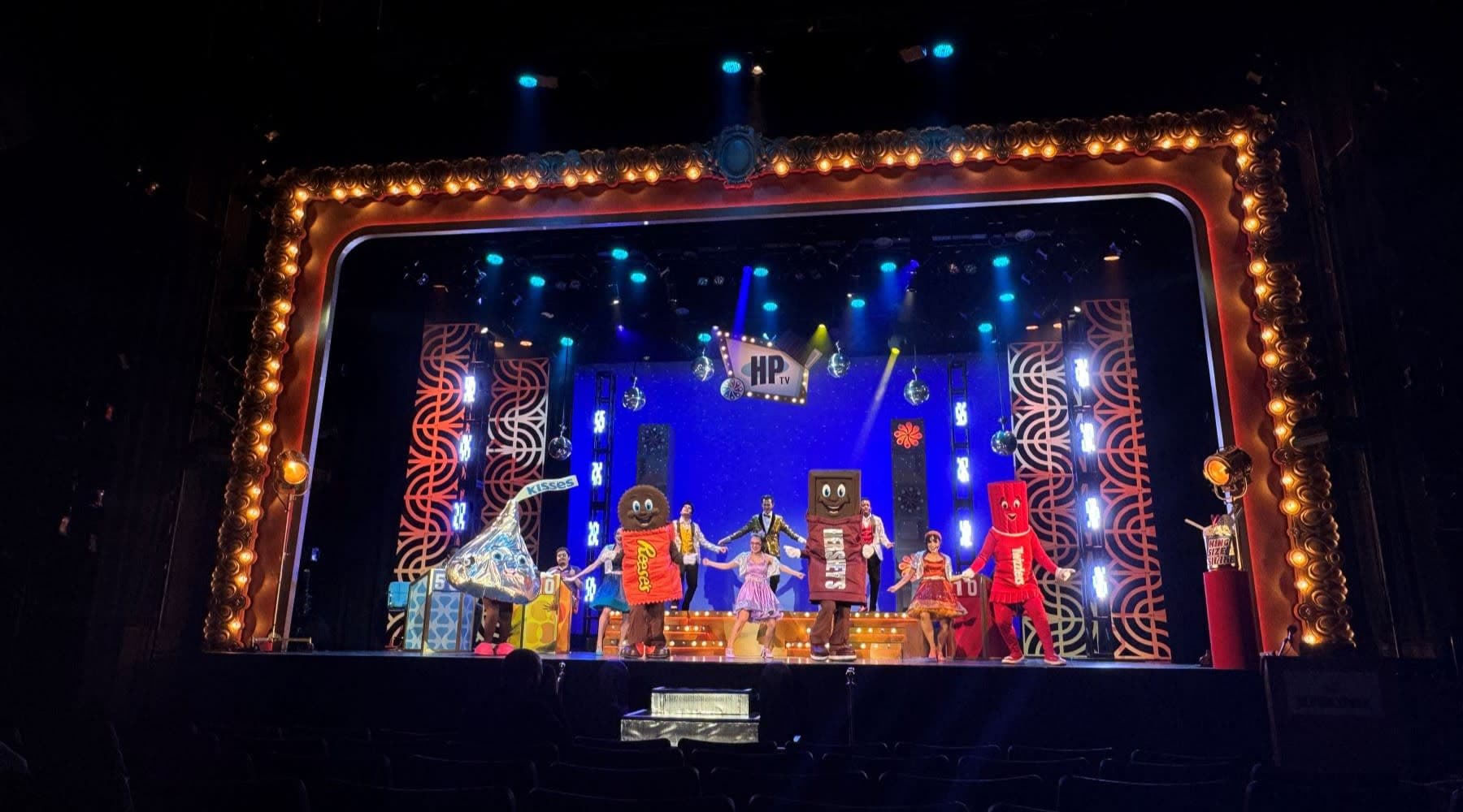 Characters on stage with cast 