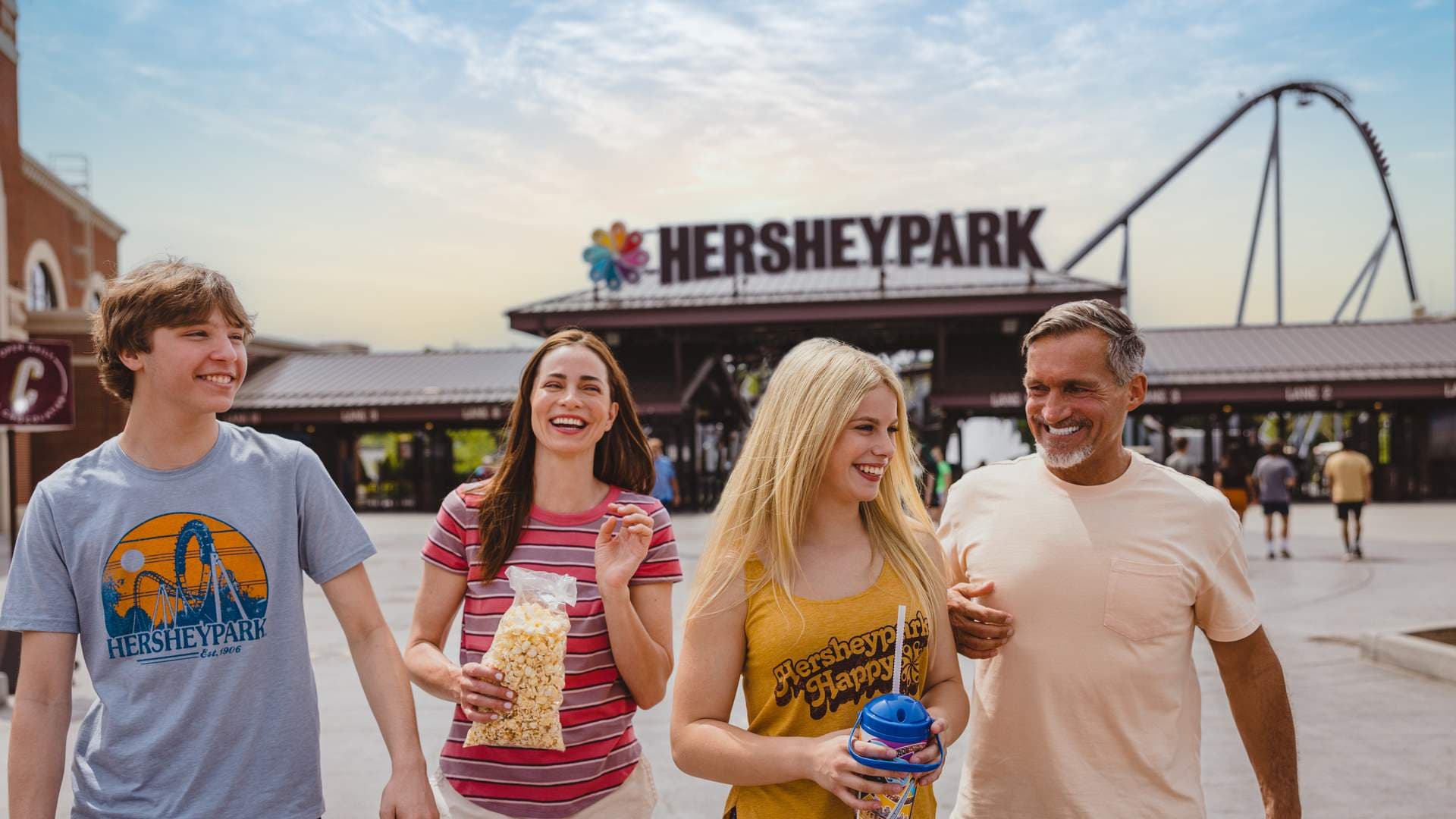 family walking in front of hersheypark gate