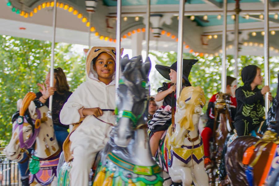 child riding carousel hersheypark halloween