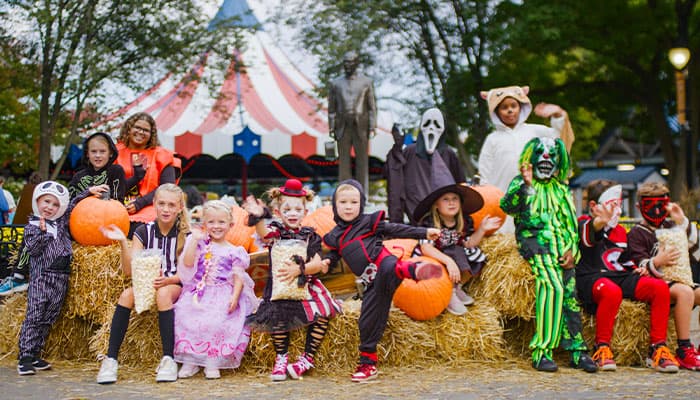 kids in costumes in action poses for hersheypark halloween