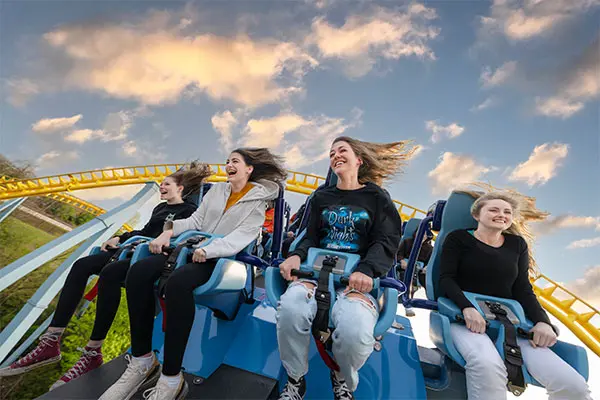 group smiling riding coaster hersheypark dark nights