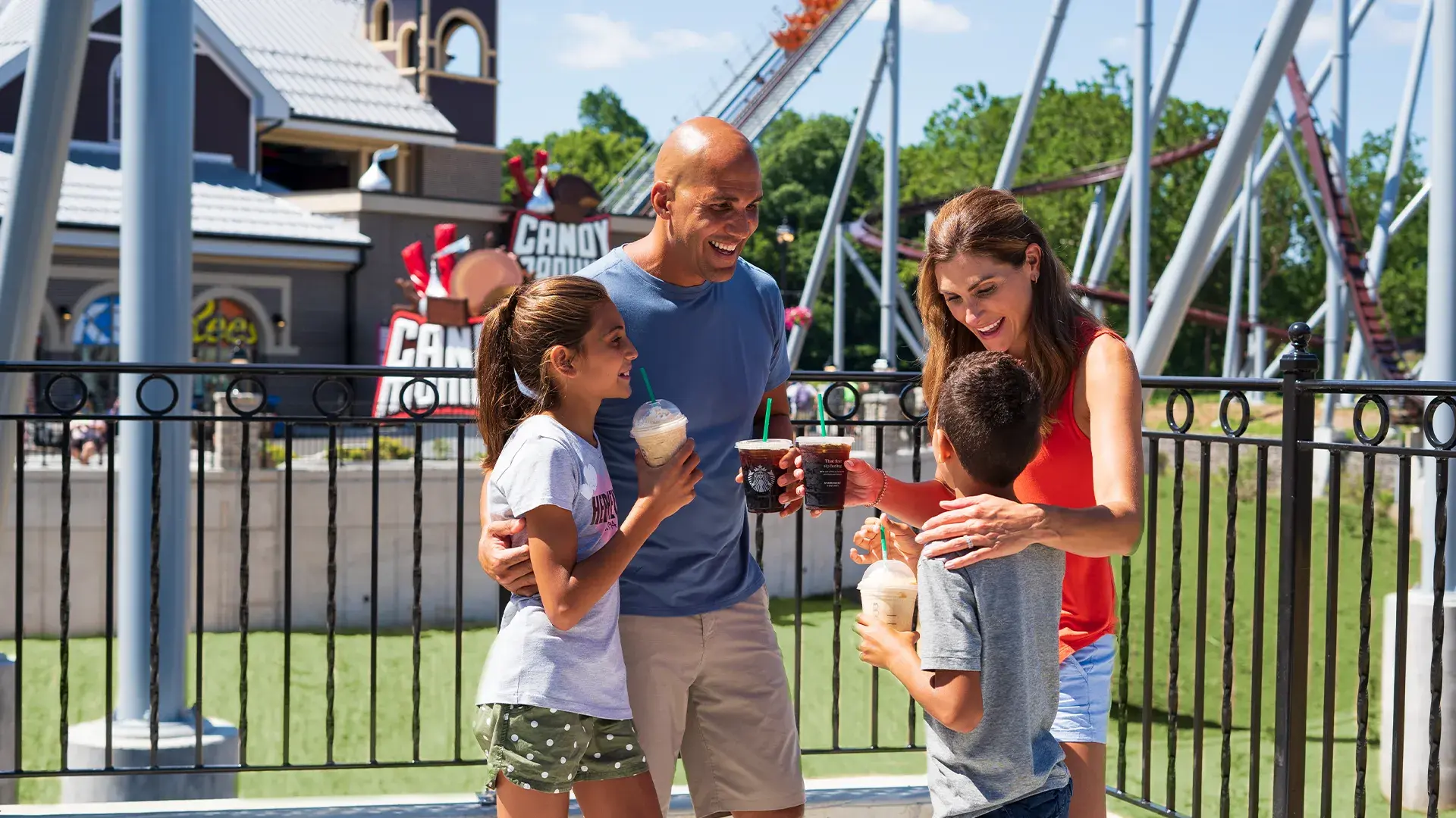 family at hersheypark holding milkshakes