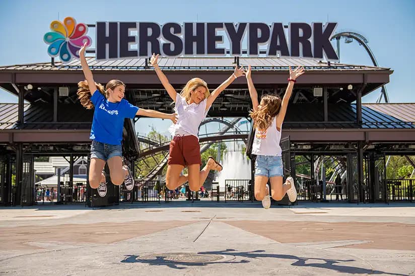 women-jumping-in-front-of-hersheypark-gate.webp
