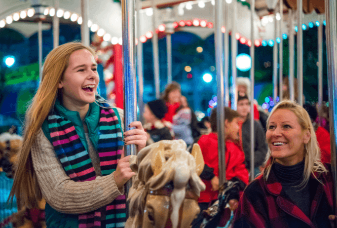 Family riding carousel during Hersheypark Christmas Candylane
