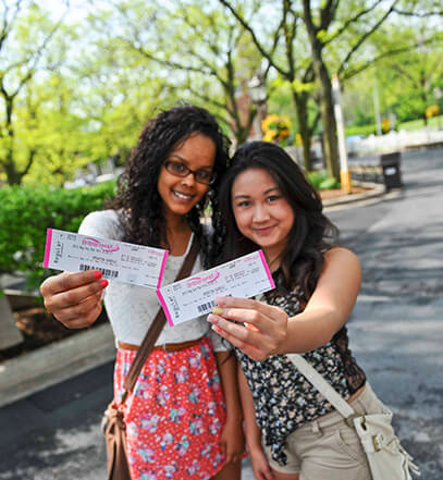 girls holding up Hersheypark Tickets