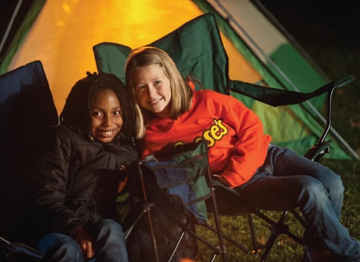 Two girls in front of campfire at Hersheypark Camping Resort