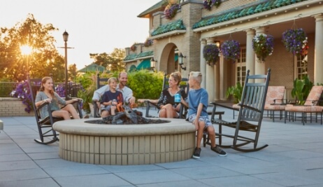 family sitting outside of resort