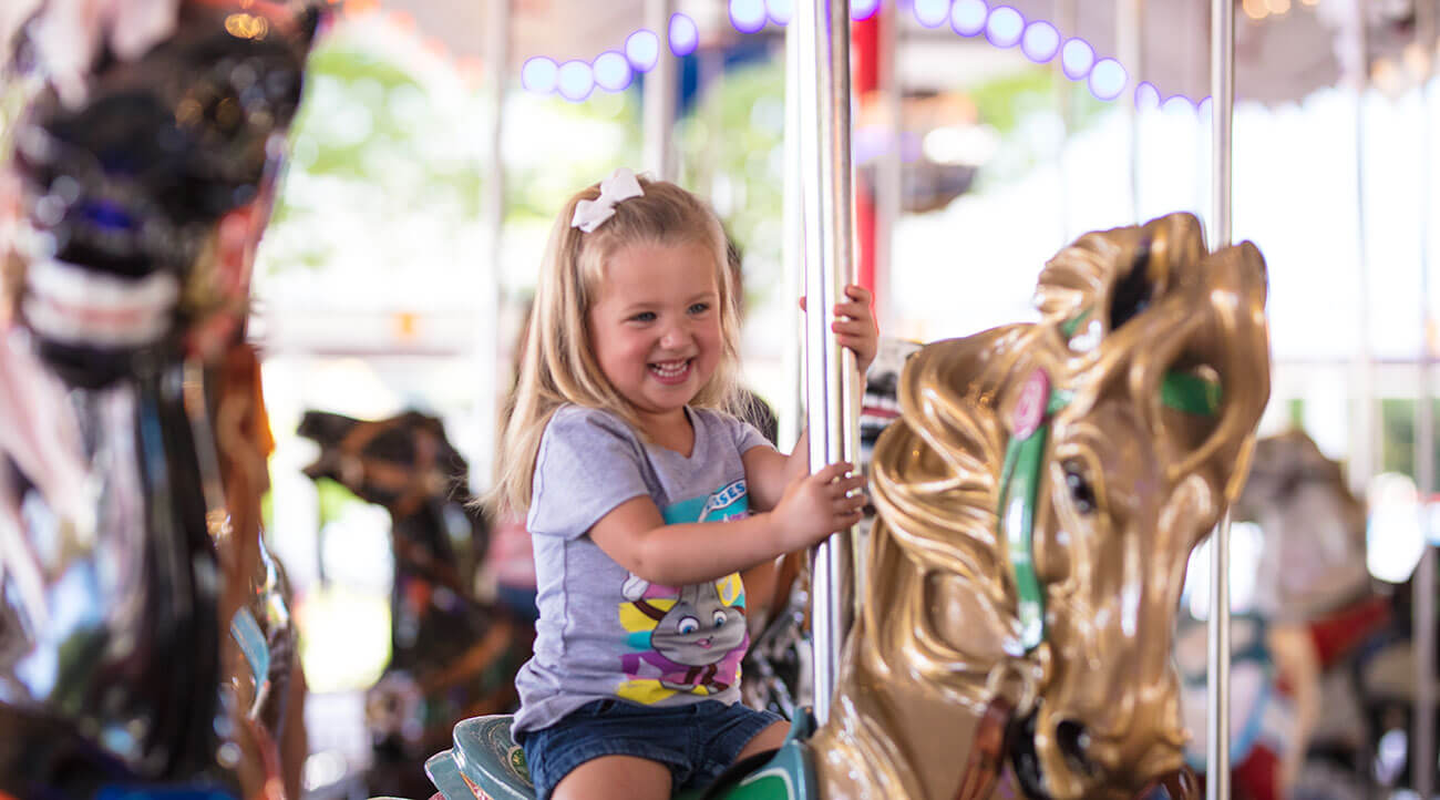 Girl Riding Carousel
