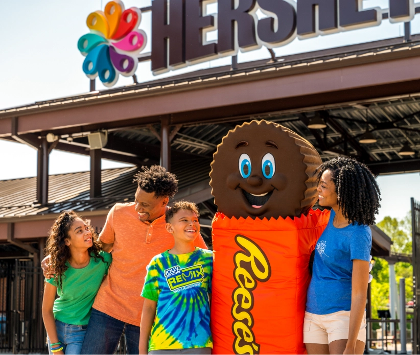 Family posing with Reeses candy Mascot
