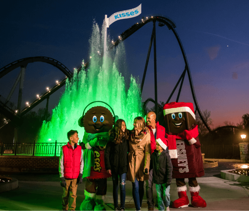 Guests standing next to Kisses fountain with Hershey's Characters