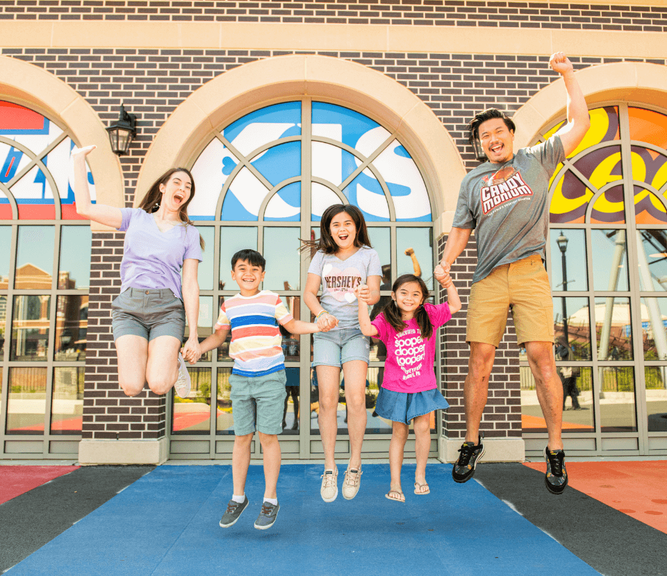 Family jumping with joy at Hersheypark